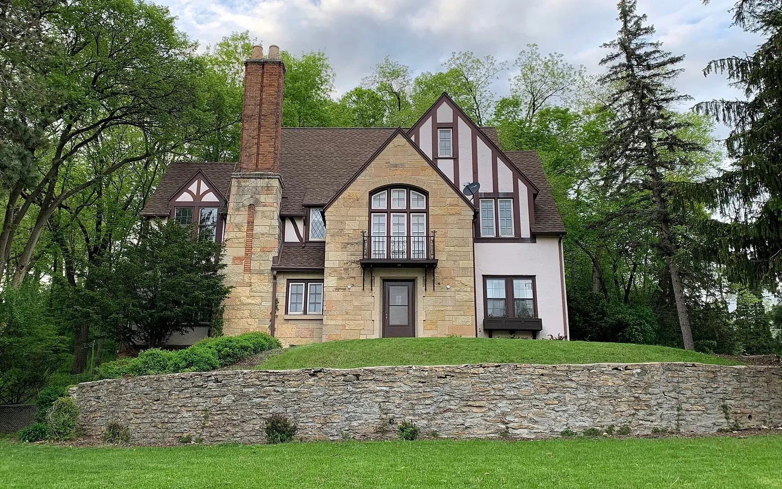 A two-story Tudor-style home with a side addition in the Historic Southwest neighborhood of Rochester, Minnesota.