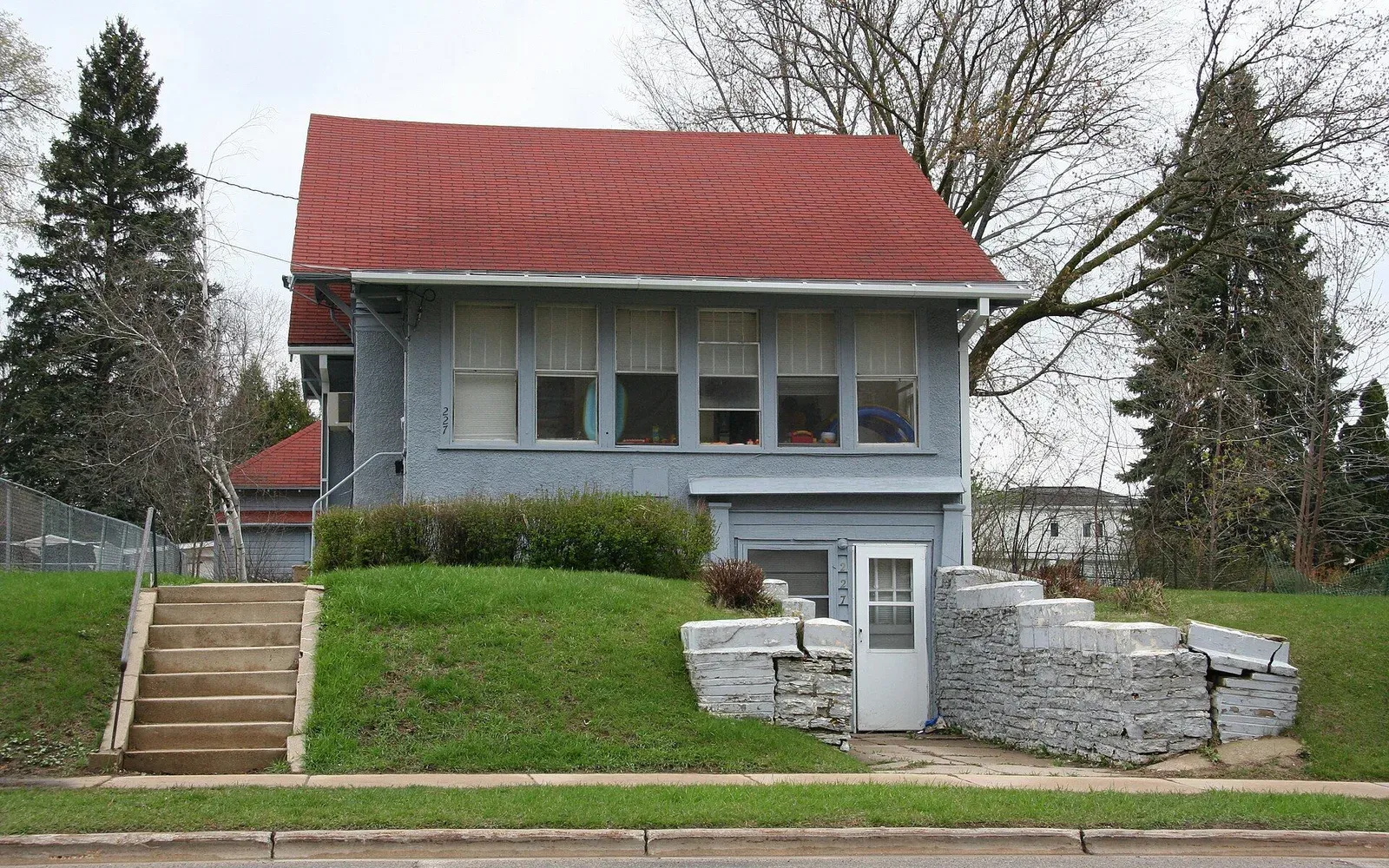 A modern home with a covered front porch on a residential street in Manor Woods, northwest Rochester, Minnesota.